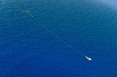 A tuna fishing boat drags a cage of nets on the Mediterranean.