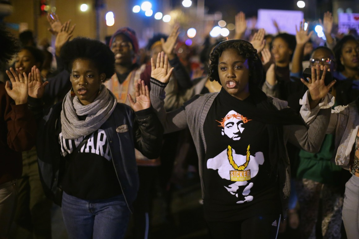 Hundreds of demonstrators, many of them Howard University students, march down the middle of U Street Northwest in Washington, D.C.