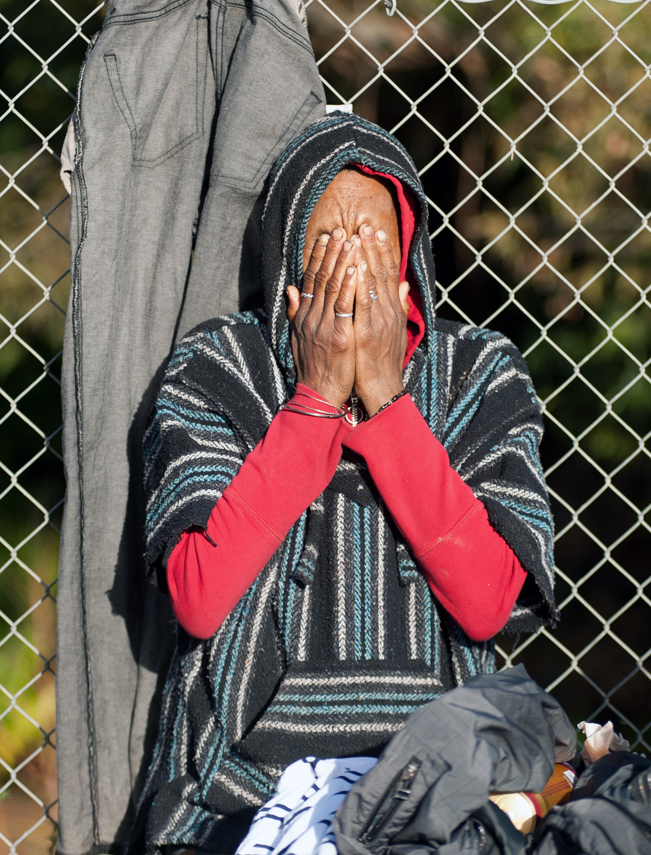 A displaced homeless person reacts as bulldozers move on a Silicon Valley homeless encampment known as 