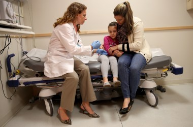 Miami Children's Hospital pediatrician Dr. Amanda Porro prepares to administer a measles vaccination to Sophie Barquin, age four, as her mother Gabrielle Barquin holds her during a visit to the Miami Children's Hospital on January 28th, 2015, in Miami, Florida.