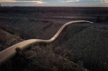 A water intake pipe for oil sands operations leads downhill to the Athabasca River on April 28th, 2015, north of Fort McMurray, Canada.