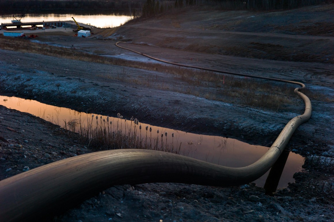 A water intake pipe for oil sands operations leads downhill to the Athabasca River on April 28th, 2015, north of Fort McMurray, Canada.