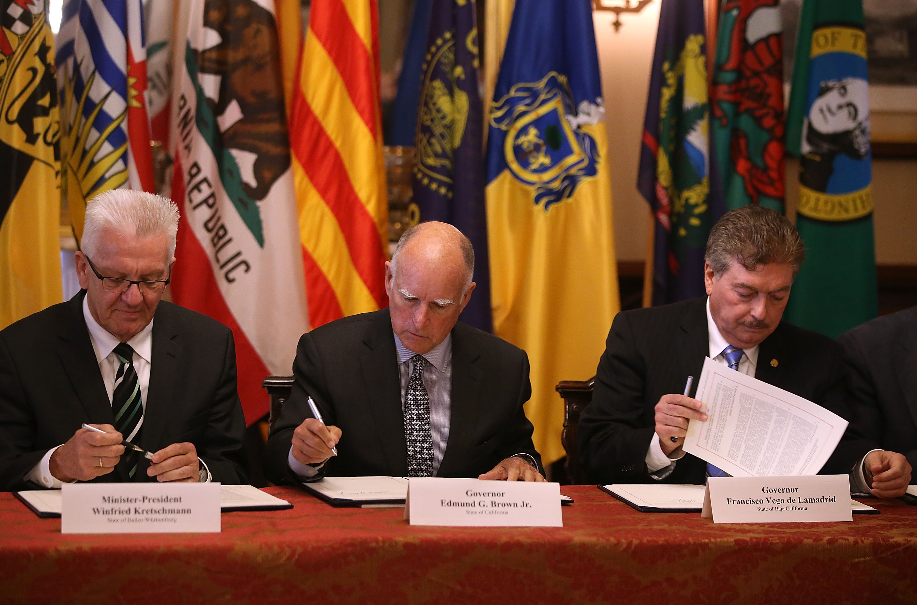 Winfried Kretschmann, minister-president of the German state of Baden-Wurttemberg, California Governor Jerry Brown, and Baja California Governor Francisco A. Vega de Lamadrid sign a climate change bill during at the Leland Stanford Mansion in Sacramento, California on May 19th, 2015.