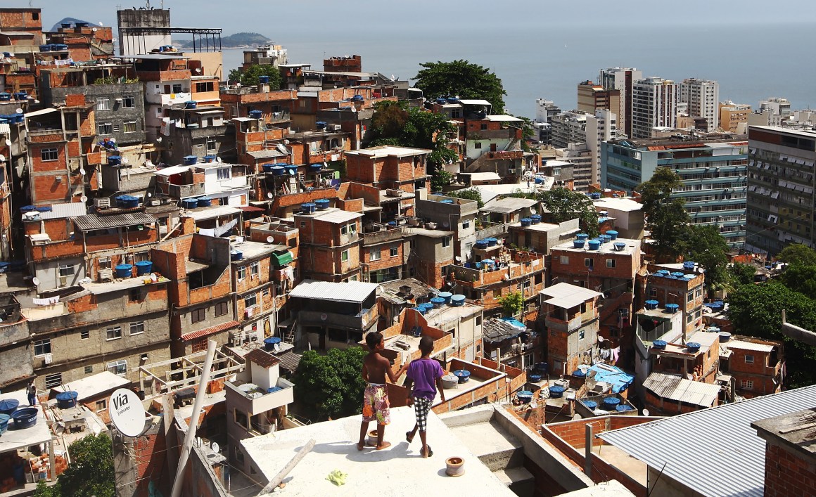 Boys gather while flying kites in the Cantagalo shantytown community next to neighboring Pavao-Pavaozinho in Rio de Janeiro, Brazil.