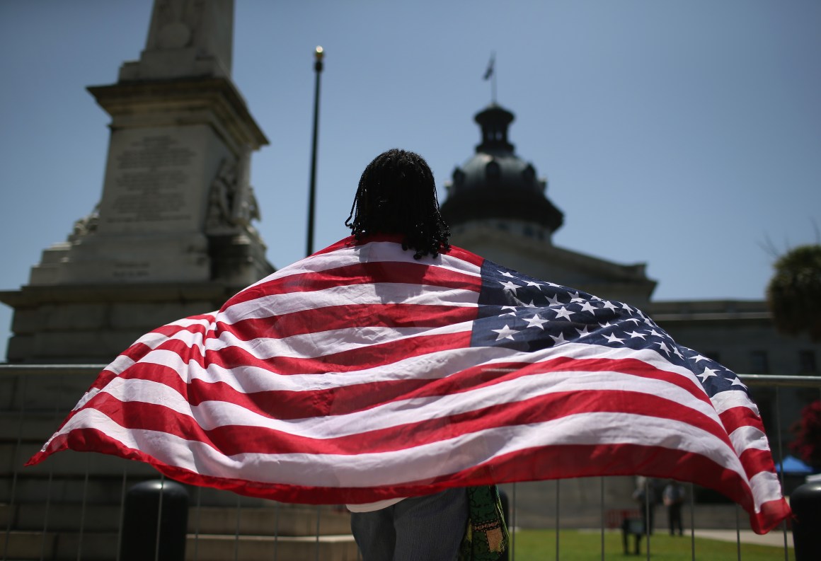 Brenda Brisbon wears the 'Stars and Stripes' after the Confederate 'Stars and Bars' was lowered from the flagpole in front of the statehouse on July 10th, 2015, in Columbia, South Carolina.