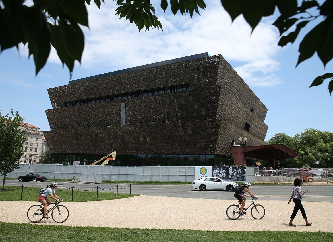 Tourists move past the Smithsonian Museum of African American History & Culture.