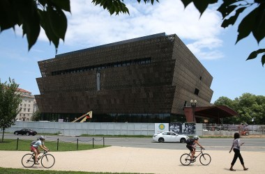 Tourists move past the Smithsonian Museum of African American History & Culture.