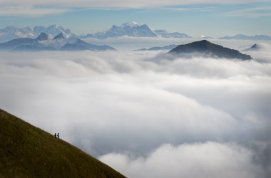 Tourists face a sea of mist engulfing the Alps from Moleson peak, Western Switzerland, on September 26th, 2015.