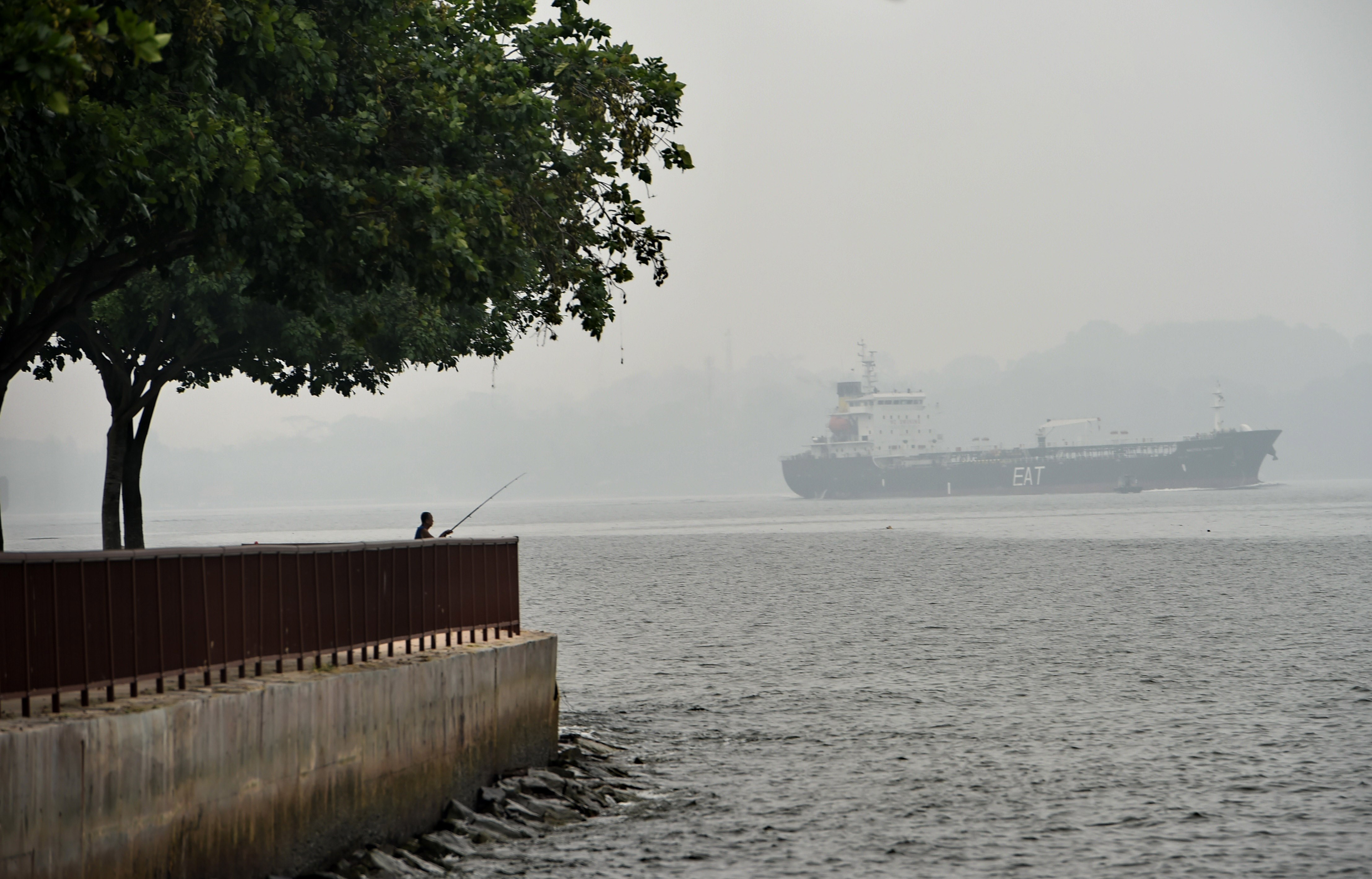 A vessel sails along the hazy Singapore strait on October 6th, 2015.