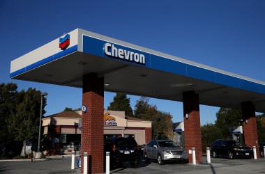 The Chevron logo is displayed at a Chevron station in Greenbrae, California.