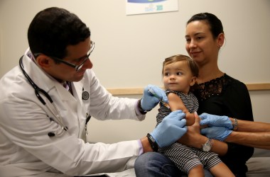 Daniela Chavarriaga holds her daughter, Emma Chavarriaga, as pediatrician Jose Rosa-Olivares, M.D., administers a measles vaccination during a visit to the Miami Children's Hospital on June 2nd, 2014, in Miami, Florida.