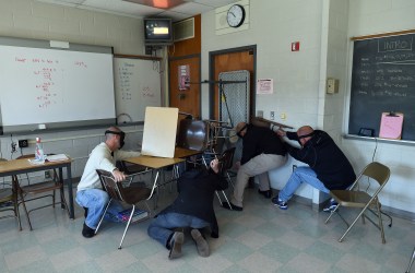 "Students" barricade a door of a classroom to block an "active shooter" during ALICE (Alert, Lockdown, Inform, Counter and Evacuate) training at the Harry S. Truman High School in Levittown, Pennsylvania, on November 3rd, 2015.