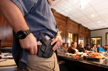 A man shows a holster at a concealed-carry permit class put on by USA Firearms Training on December 19th, 2015, in Provo, Utah.