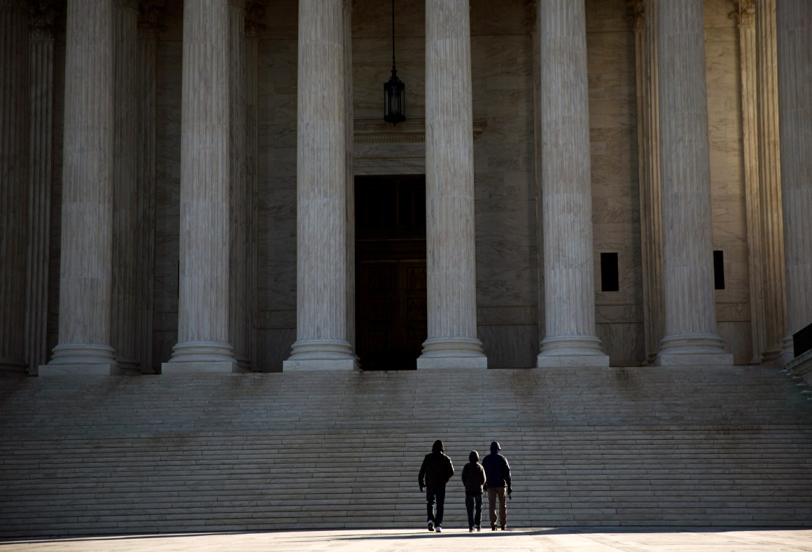 Visitors walk outside the Supreme Court.