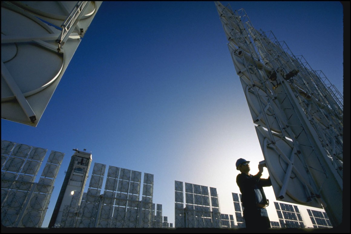 A technician servicing photovoltaic cells in a solar energy farm in Albuquerque, New Mexico.