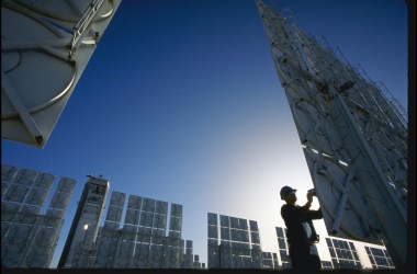 A technician servicing photovoltaic cells in a solar energy farm in Albuquerque, New Mexico.