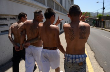 Alleged members of the 18 gang gesture as they walk during their presentation to the press in San Salvador on February 26th, 2016.