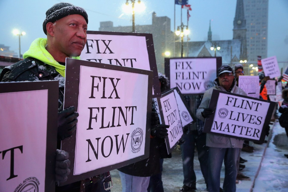 Demonstrators demand action from the Republican presidential candidates about the water crisis in Flint outside the historic Fox Theater.