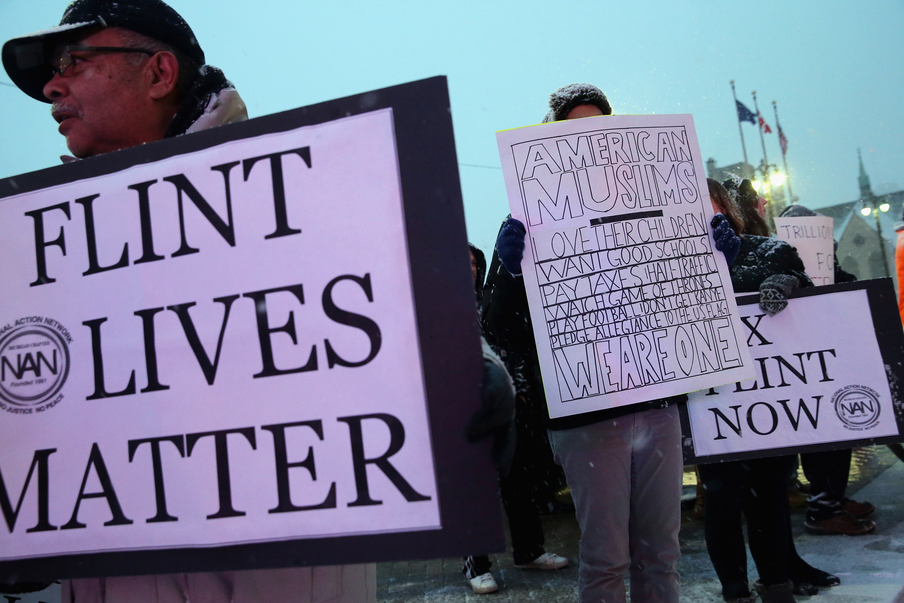 Demonstrators demand action from the Republican presidential candidates about the water crisis in Flint outside the historic Fox Theater.