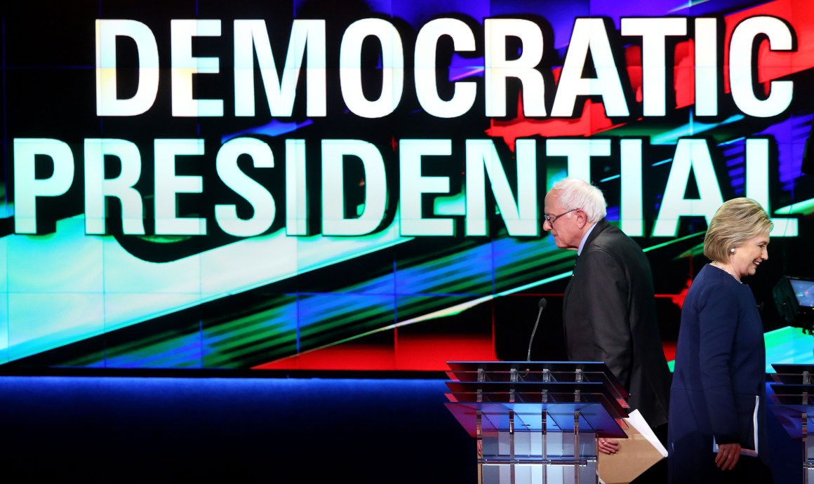 Bernie Sanders and Hillary Clinton walk off stage during a break in a primary debate on March 6th, 2016, in Flint, Michigan.