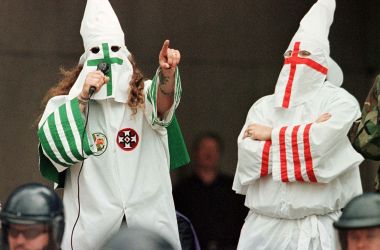 The Grand Dragon of the Michigan Ku Klux Klan (left) addresses the crowd as another Klan member looks on during a rally on August 21st, 1999, in Cleveland, Ohio.