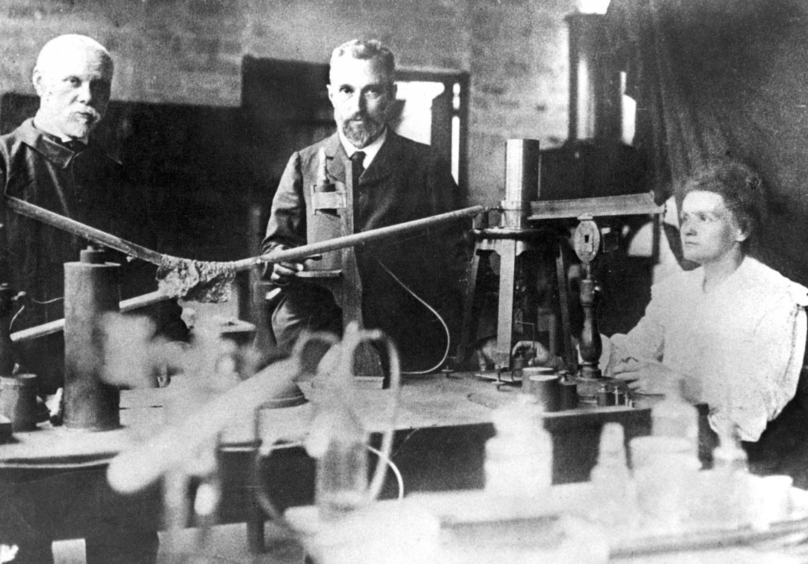 This picture from around 1900 shows Marie Curie (right), her husband Pierre (center), and assistant Edison Petit (left) working in their makeshift laboratory in Paris. Marie Curie and her husband discovered radium and won the Nobel prize for physics in 1903. Marie Curie was the first person to receive two Nobel prizes when she was awarded the Nobel prize for chemistry in 1911.