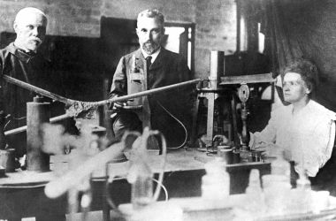 This picture from around 1900 shows Marie Curie (right), her husband Pierre (center), and assistant Edison Petit (left) working in their makeshift laboratory in Paris. Marie Curie and her husband discovered radium and won the Nobel prize for physics in 1903. Marie Curie was the first person to receive two Nobel prizes when she was awarded the Nobel prize for chemistry in 1911.