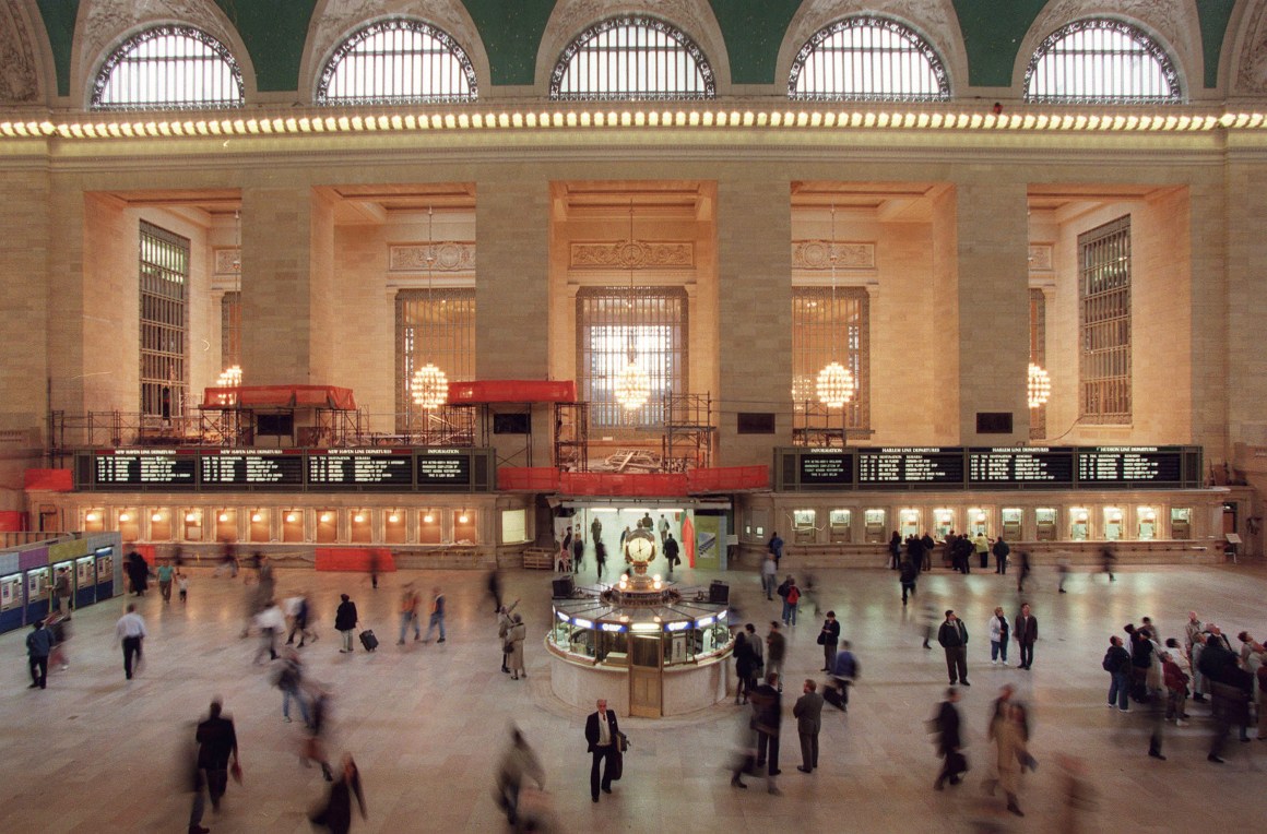 Commuters and train passengers walk through the main concourse of of Grand Central Station.