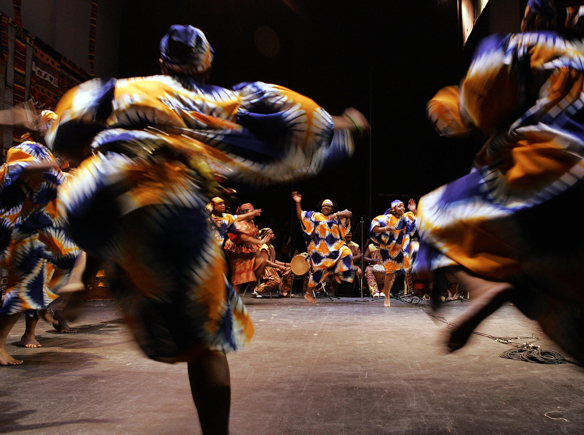 African Heritage Dancers dance to the African Heritage Drummers during a Kwanzaa celebration at the Lincoln Theater in Washington, D.C. Kwanzaa is a pan-African holiday established in 1966 celebrating family, community, and culture through seven principles of unity, self-determination, collective work and responsibility, cooperative economics, purpose, creativity, and faith.