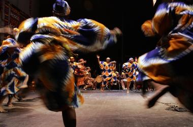 African Heritage Dancers dance to the African Heritage Drummers during a Kwanzaa celebration at the Lincoln Theater in Washington, D.C. Kwanzaa is a pan-African holiday established in 1966 celebrating family, community, and culture through seven principles of unity, self-determination, collective work and responsibility, cooperative economics, purpose, creativity, and faith.