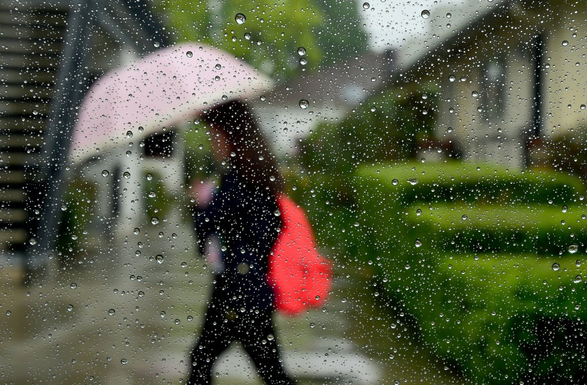 A pedestrian uses her umbrella in the rain in Alhambra, California, on April 8th, 2016.