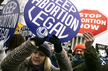 Pro-life and pro-choice activists hold signs outside the U.S. Supreme Court during the 'March for Life' event January 24, 2005 in Washington, DC.