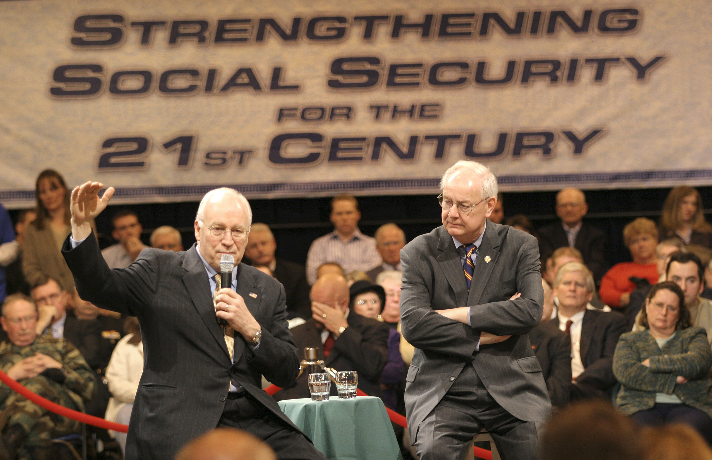 U.S. Vice President Dick Cheney (L) gestures as he speaks at a town hall meeting on social security as U.S. Congressman Joe Schwarz (R-MI) listens March 24th, 2005, in Battle Creek, Michigan.