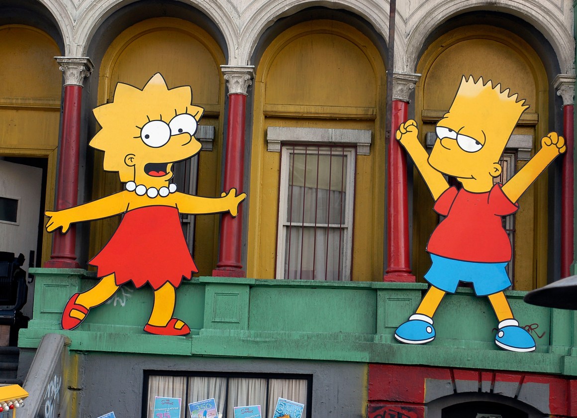 Lisa Simpson and Bart Simpson cut-outs on display at a block party in Los Angeles, California.