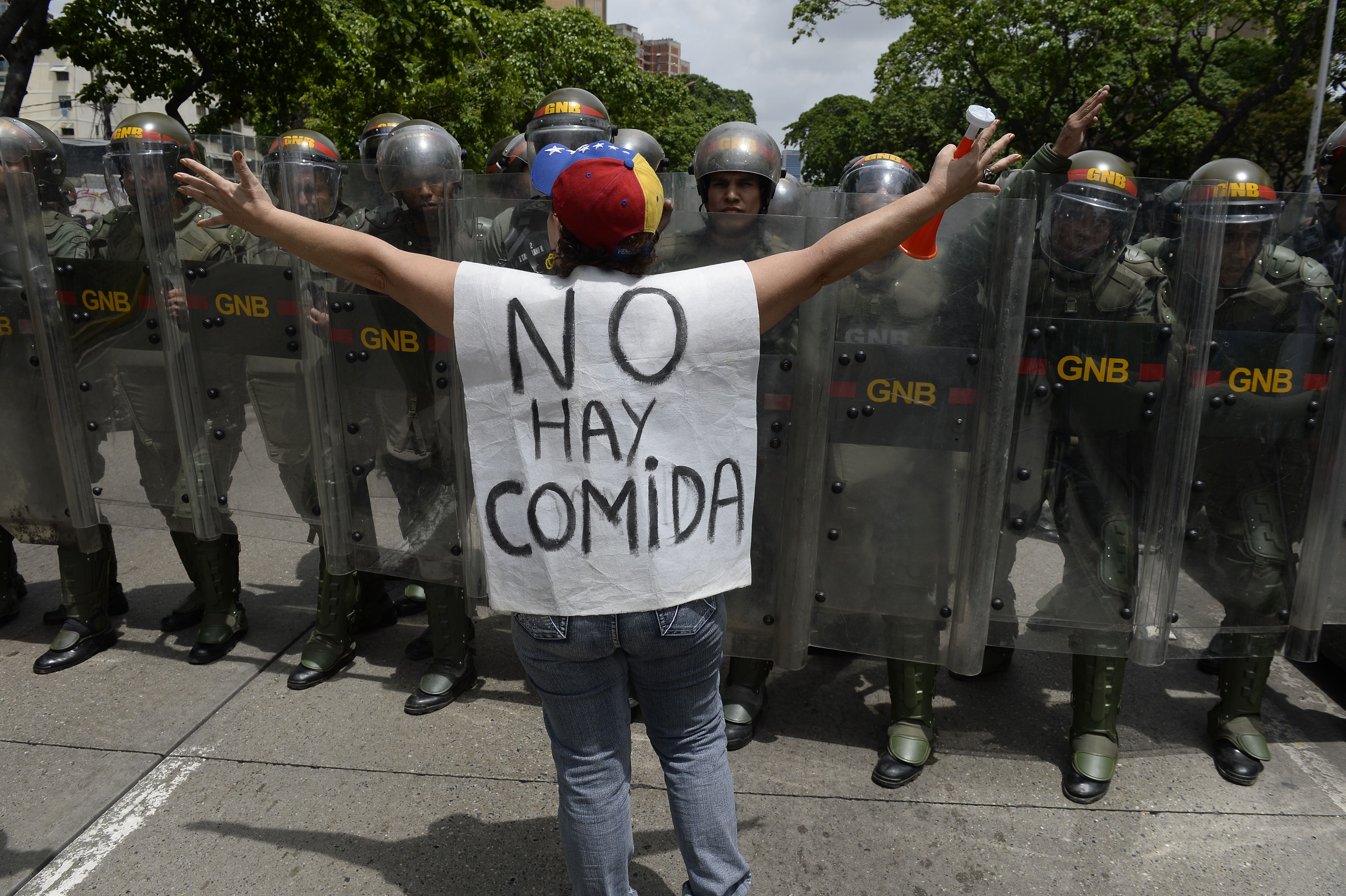 A woman with a sign reading 