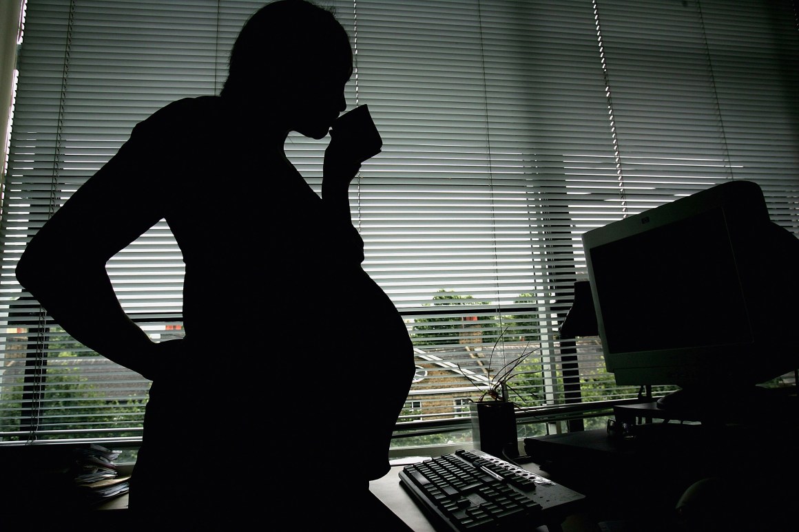 A woman is seen stood at her office work station on July 18th, 2005, in London, England.