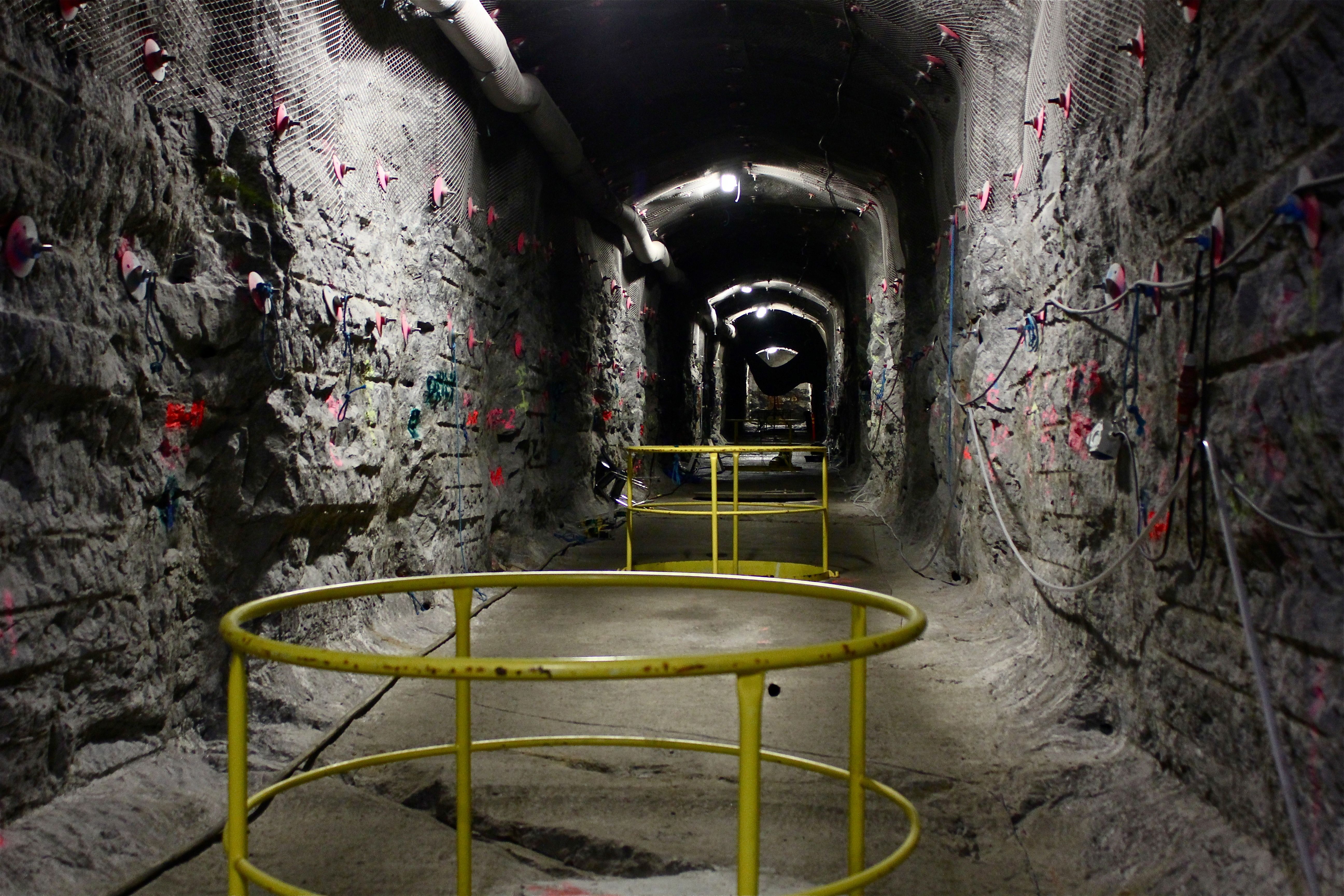 Inside the world's first underground repository for highly radioactive nuclear waste, guardrails surround cylindrical burial holes awaiting their lethal deposits.