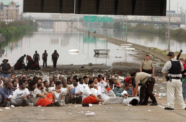 Police watch over prisoners from Orleans Parish Prison who were evacuated from their prison to the highway due to high water in New Orleans, Louisiana.