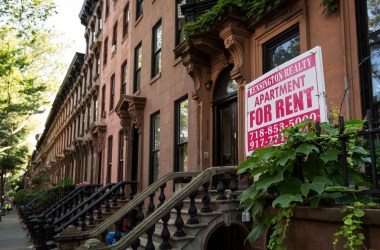 A sign advertises an apartment for rent along a row of brownstone townhouses in the Fort Greene neighborhood in the Brooklyn borough of New York City.