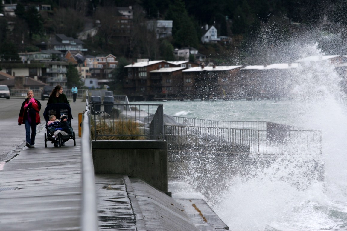 Shannon Mirich (R) of Des Moines, Washington, and friend, Rachel Grice, of Issaquah, Washington, walk with their children along Beach Drive in Seattle.