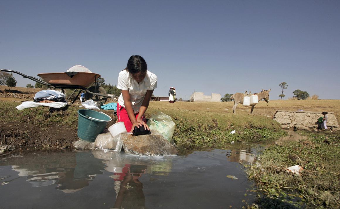 A Mexican Mazahua girl washes some clothes at La Presita reservoir in Loma de Juarez, Mexico.