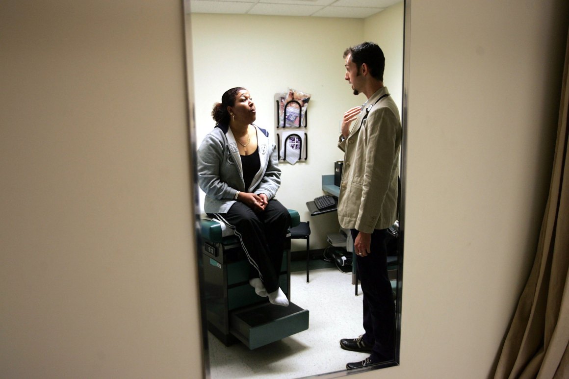 Dr. Ethan Brackett listens during an examination of patient Cristina Valdez at the Codman Square Health Center on April 11th, 2006, in Dorchester, Massachusetts.