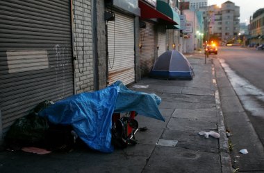 A police car stops near a homeless encampment on April 19th, 2006, in Los Angeles, California.