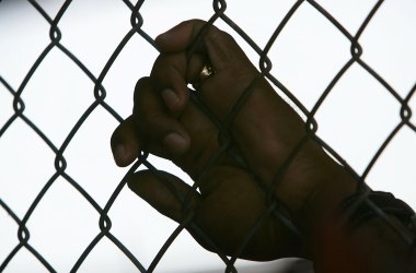 An inmate holds onto a fence at the Louisiana State Penitentiary in Angola, Louisiana.