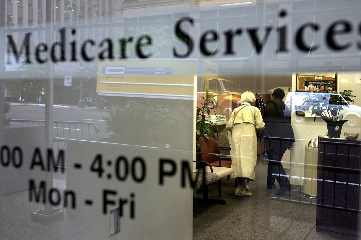 Two people walk inside a Medicare Services office in New York City.