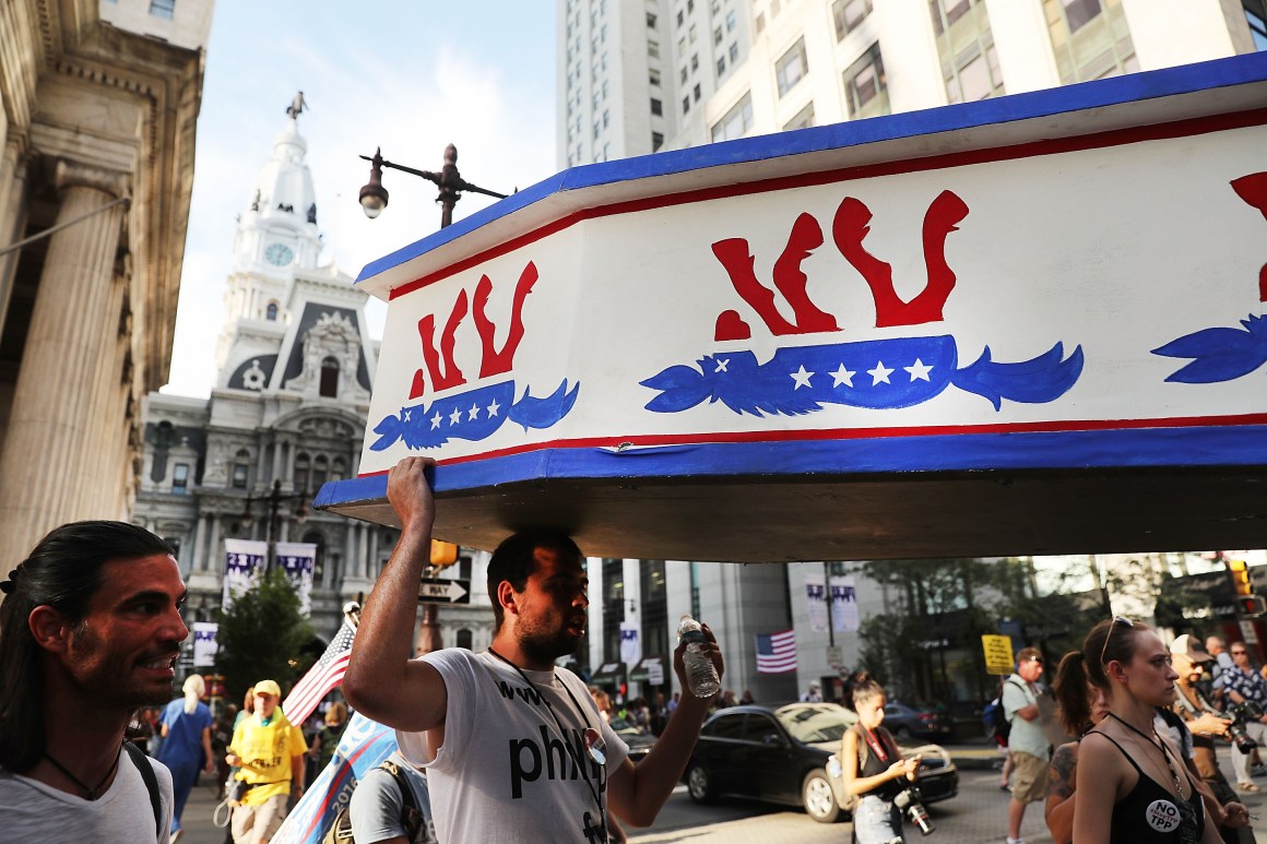 Protesters hold a wooden coffin with an upside down donkey representing the Democratic Party in downtown Philadelphia during the Democratic National Convention on July 26th, 2016, in Philadelphia, Pennsylvania.