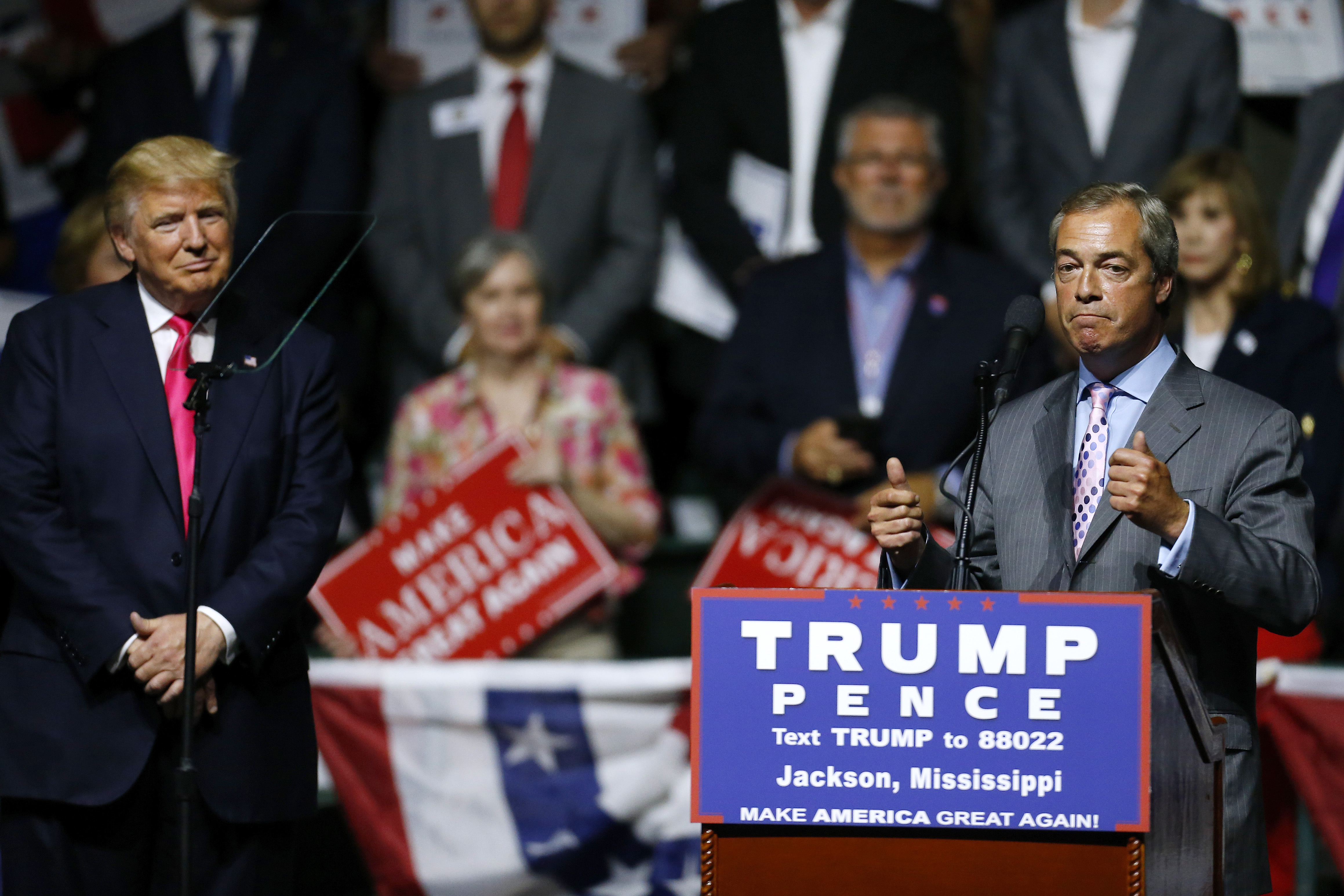 Then-presidential candidate Donald Trump listens to United Kingdom Independence Party leader Nigel Farage during a campaign rally at the Mississippi Coliseum in Jackson, Mississippi, on August 24th, 2016.