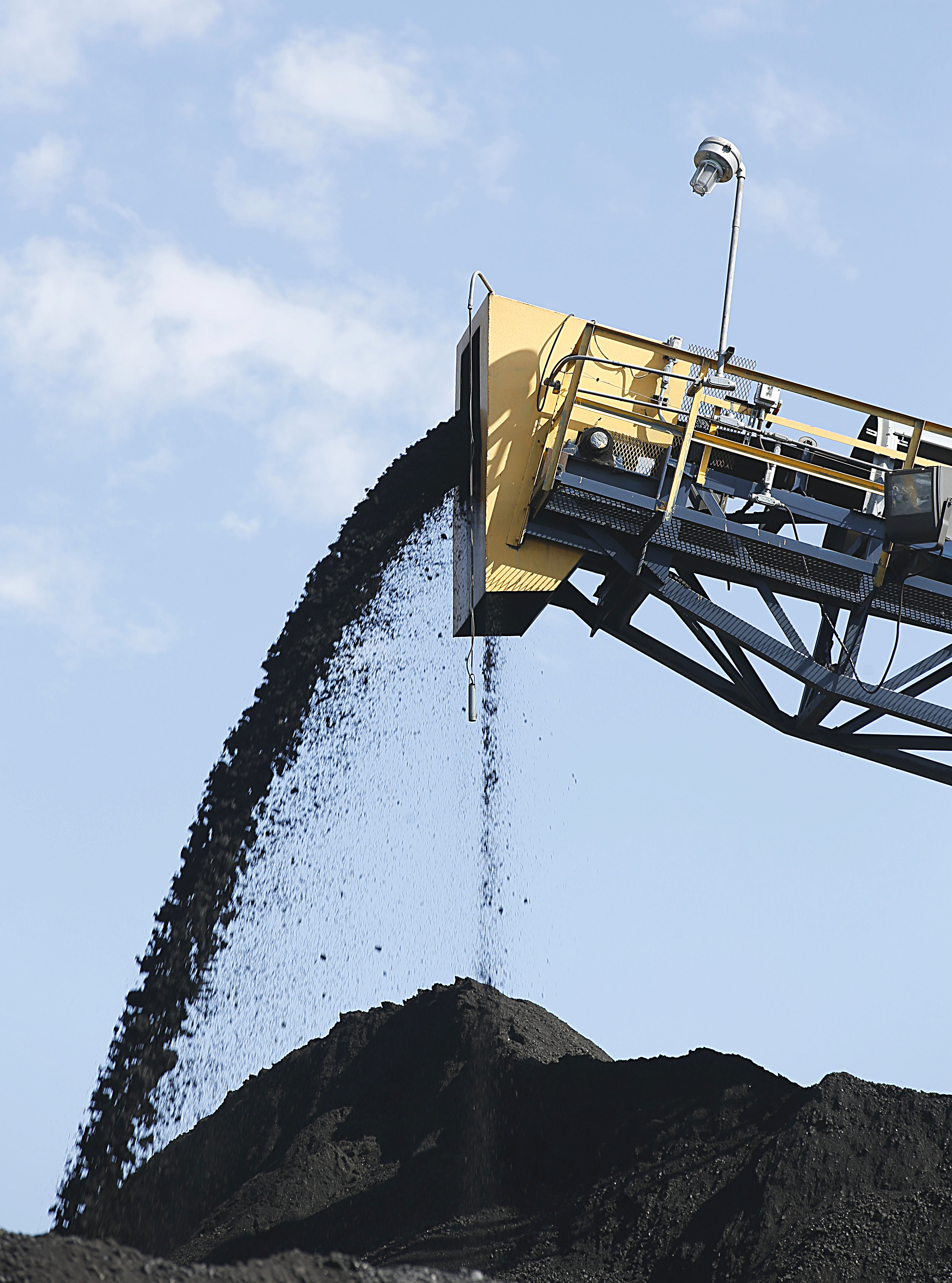 Coal falls off a conveyer belt as it's off loaded from trucks from local coal mines at the Savage Energy Terminal.