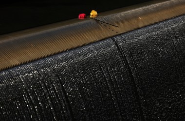 Two roses sit on the edge of one of the reflecting pools at the September 11th Memorial following a commemoration ceremony for the victims of the terrorist attacks on September 11th, 2016, in New York City.