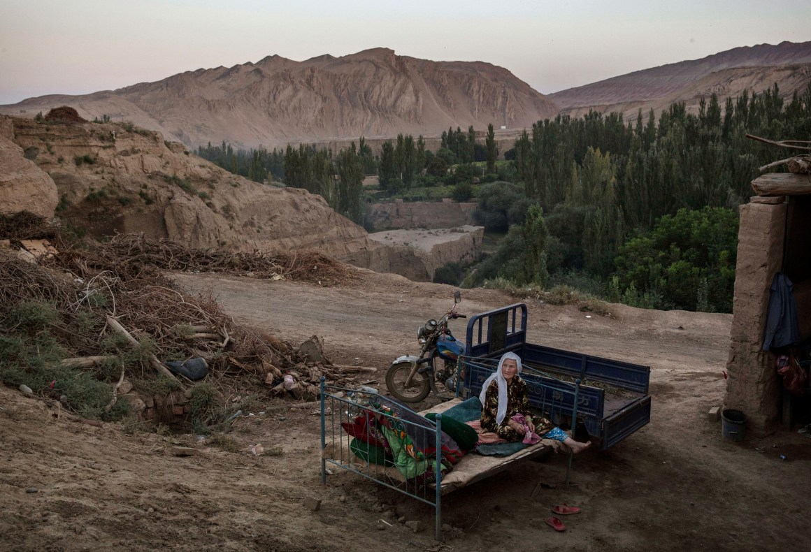 A Uyghur woman sits on a bed outside on September 12th, 2016, in Turpan County, in the far western Xinjiang province of China.